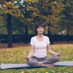 “움직이는 명상”… 뇌와 몸을 동시에 깨우는 ‘마인드풀 무브먼트’ Woman meditating in a park during autumn.